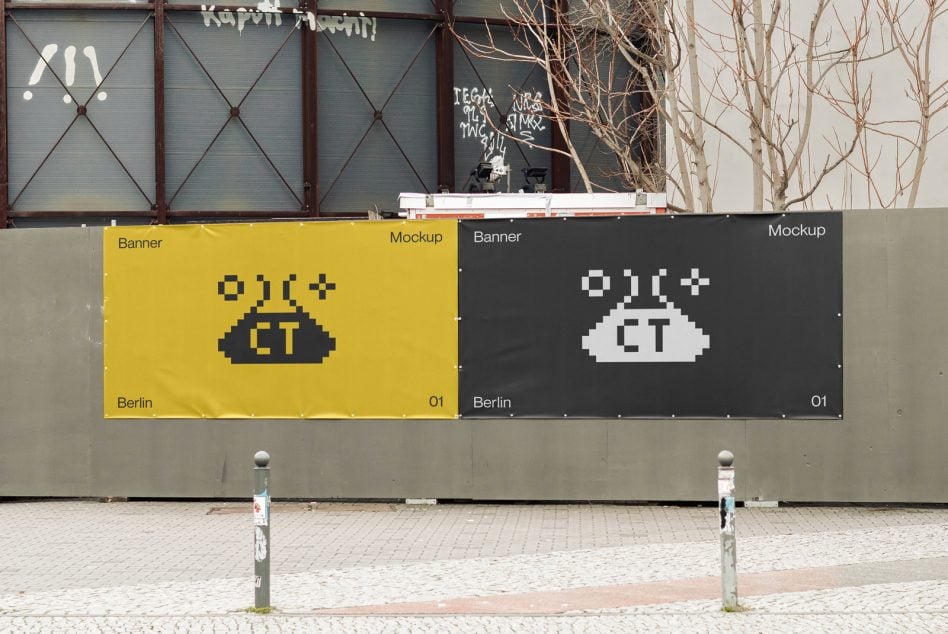 Two side by side outdoor banners, yellow left with dark pixel alien, charcoal right with white version
